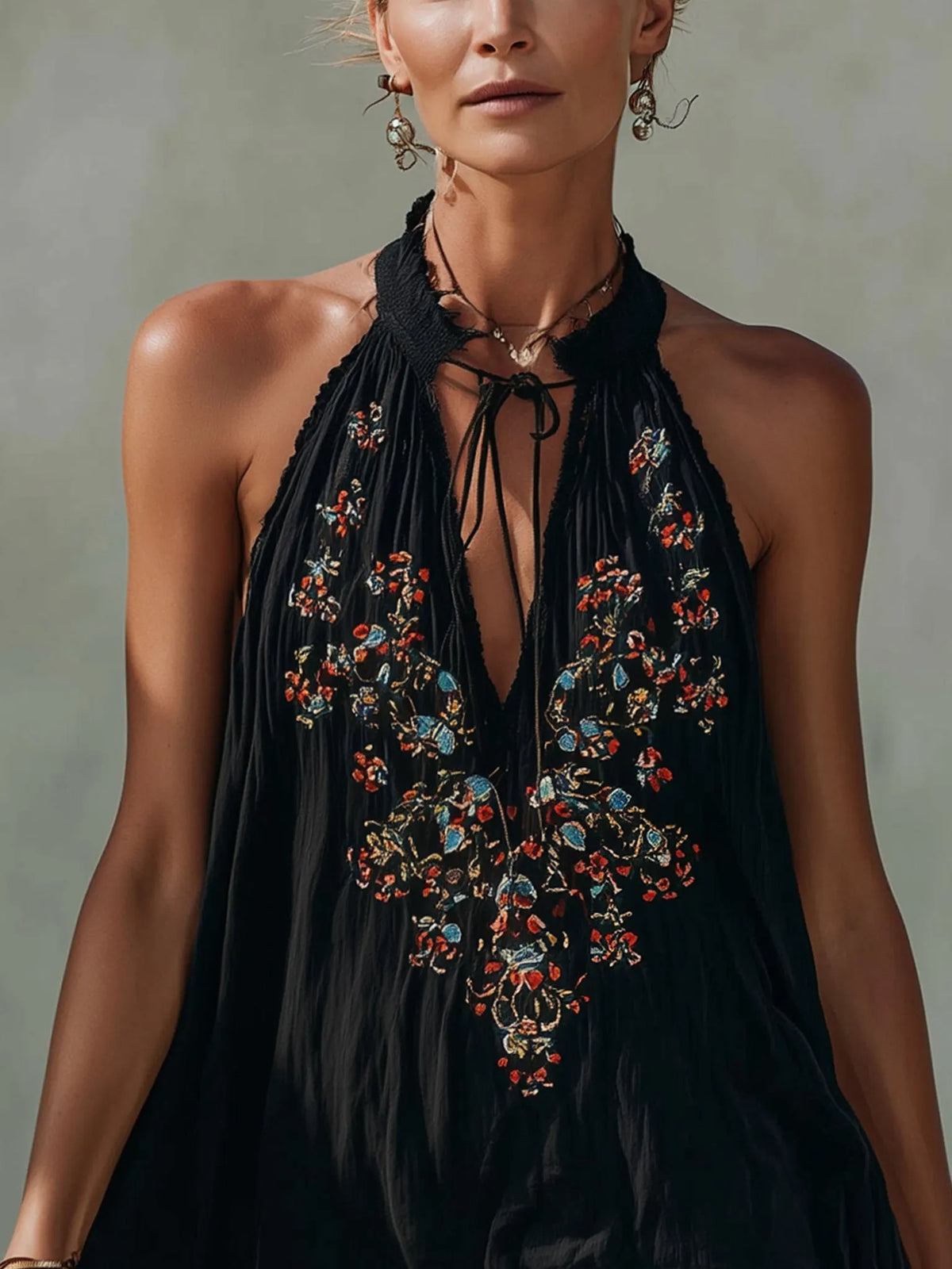 Black sleeveless mini dress with embroidery and a spliced lace hem