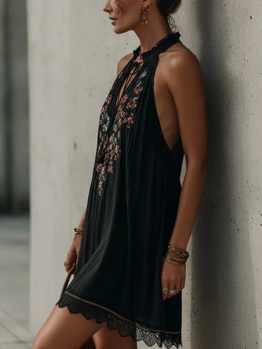 Black sleeveless mini dress with embroidery and a spliced lace hem